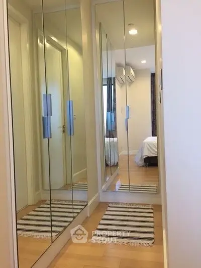 Modern bedroom with mirrored closet doors and cozy decor