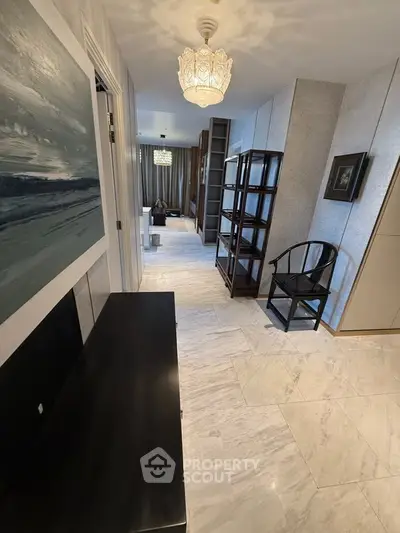 Elegant hallway with marble flooring and stylish decor leading to a cozy living area.