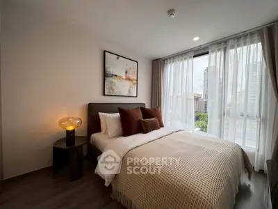 Modern bedroom with large window and stylish decor in urban apartment