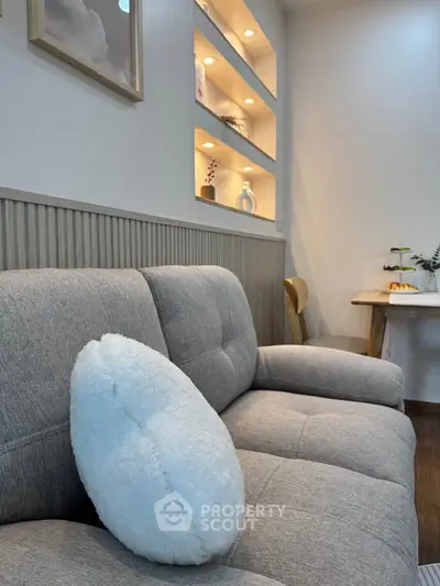Cozy living room with modern sofa and elegant wall shelving