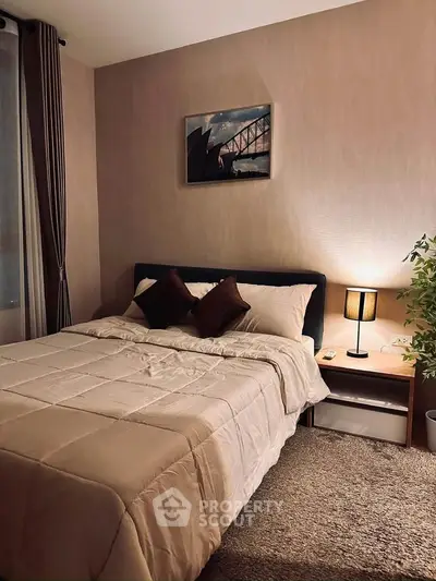 Cozy bedroom with stylish decor and warm lighting, perfect for relaxation.