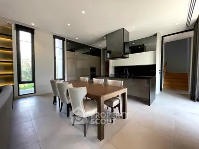 Modern open-plan kitchen and dining area with sleek design and natural light.