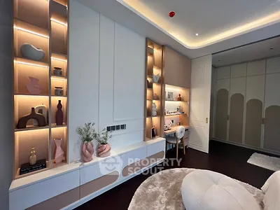 Luxurious modern living room with elegant built-in shelves and cozy seating area.
