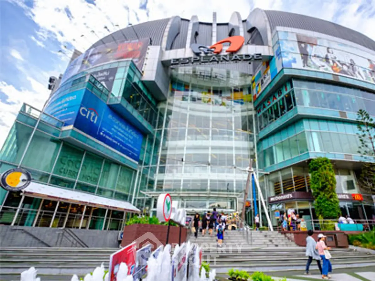 Modern commercial building with glass facade and vibrant signage, ideal for retail and business opportunities.