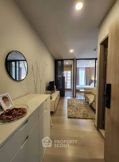 Modern apartment hallway leading to a cozy bedroom with stylish decor.
