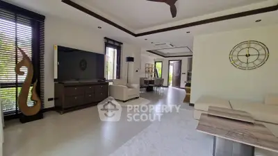 Spacious modern living room with elegant decor and large windows for natural light.