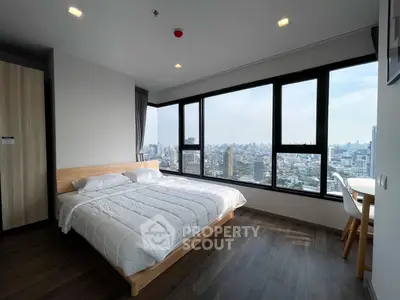 Spacious bedroom with panoramic city view and modern furnishings