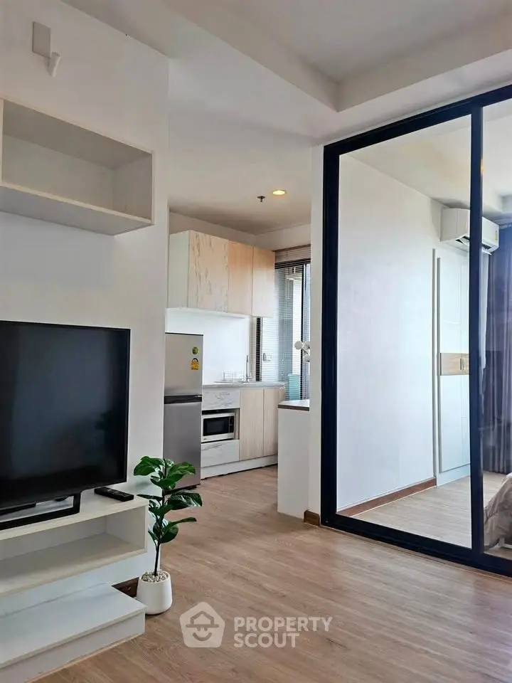 Modern living room with open kitchen and large glass doors