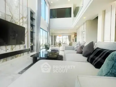 Luxurious modern living room with high ceilings and elegant decor