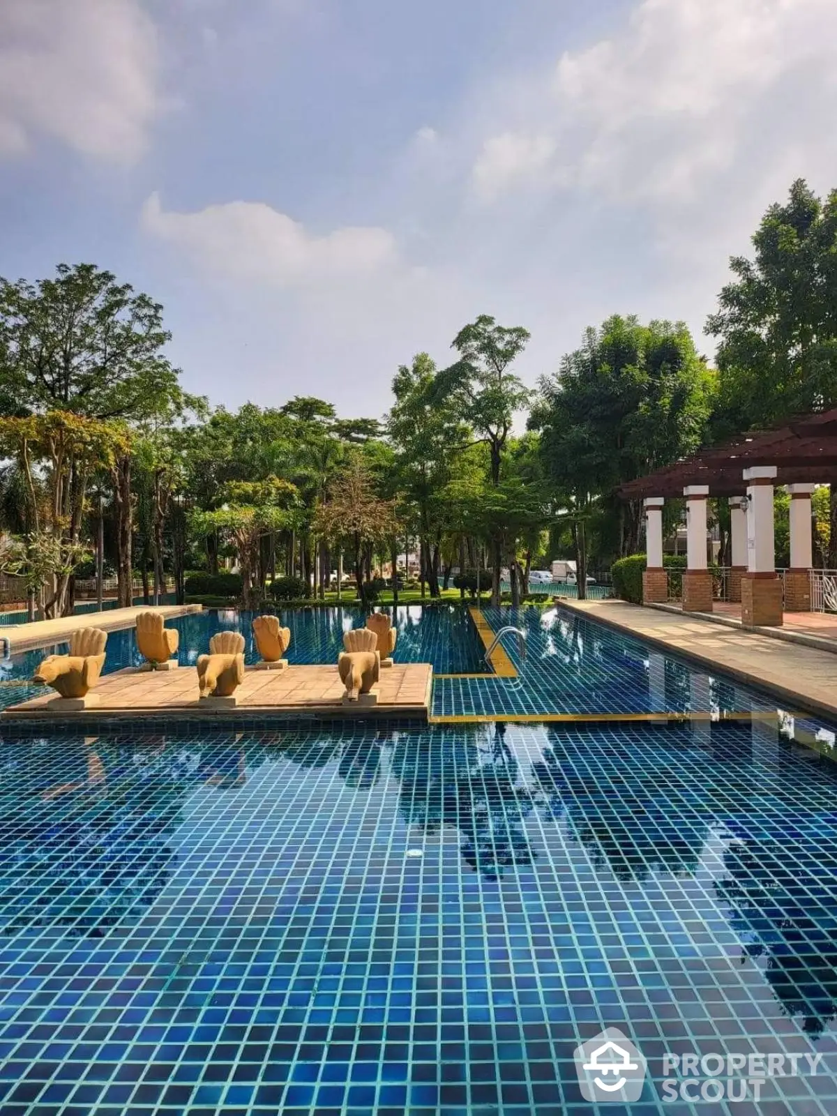 Luxurious outdoor pool area with lush greenery and elegant design, perfect for relaxation and leisure.