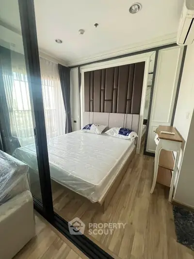 Modern bedroom with stylish decor and large window for natural light