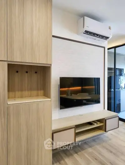 Modern living room with sleek TV setup and stylish wooden cabinetry