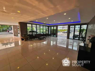 Spacious modern building entrance with glass walls and sleek tile flooring