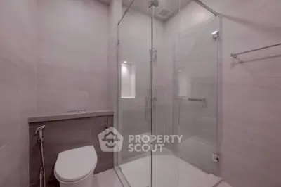 Modern bathroom with glass shower enclosure and sleek design