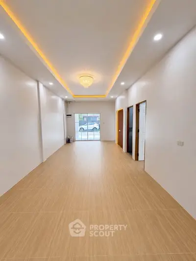 Spacious modern living room with elegant lighting and large windows