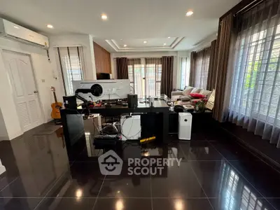 Spacious modern living room with sleek black flooring and large windows
