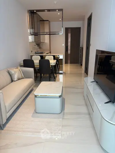 Modern living room with elegant furniture and open kitchen layout in a stylish apartment.