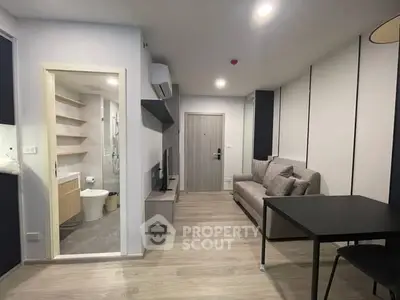 Modern apartment interior with open living room and bathroom view