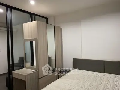 Modern bedroom with sleek wardrobe and cozy bed in stylish apartment.