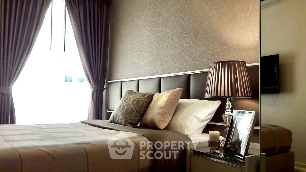 Luxurious bedroom with elegant decor and soft lighting, featuring plush bedding and stylish curtains.