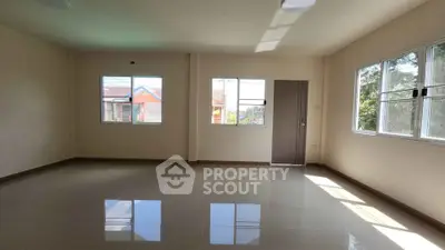 Spacious empty living room with large windows and glossy tiled floor