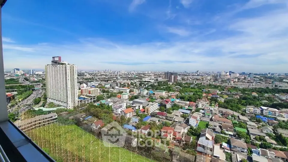 Stunning cityscape view from a high-rise building showcasing urban skyline and greenery.