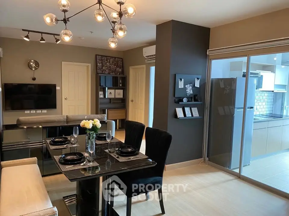 Modern dining area with elegant decor and open kitchen layout in a stylish apartment.
