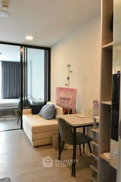 Modern living room with cozy sofa and stylish decor in a contemporary apartment.