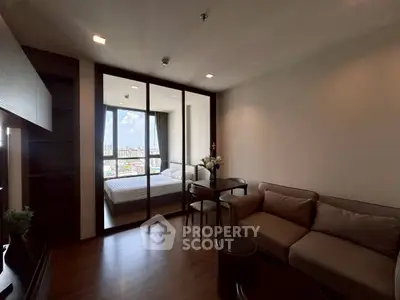 Modern living room with cozy sofa and city view bedroom in background