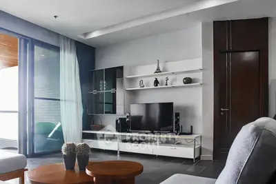 Modern living room with sleek furniture and large window for natural light.