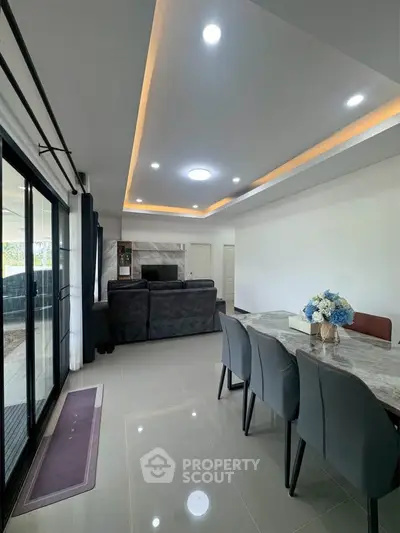 Spacious modern living room with elegant dining area and stylish lighting