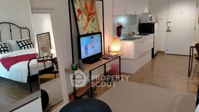 Modern studio apartment with open kitchen and cozy living area, featuring stylish decor and a comfortable bedroom.