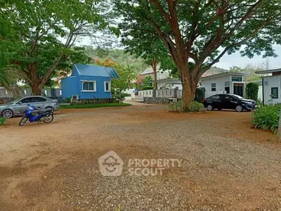 Charming residential area with small houses and lush greenery, perfect for serene living.
