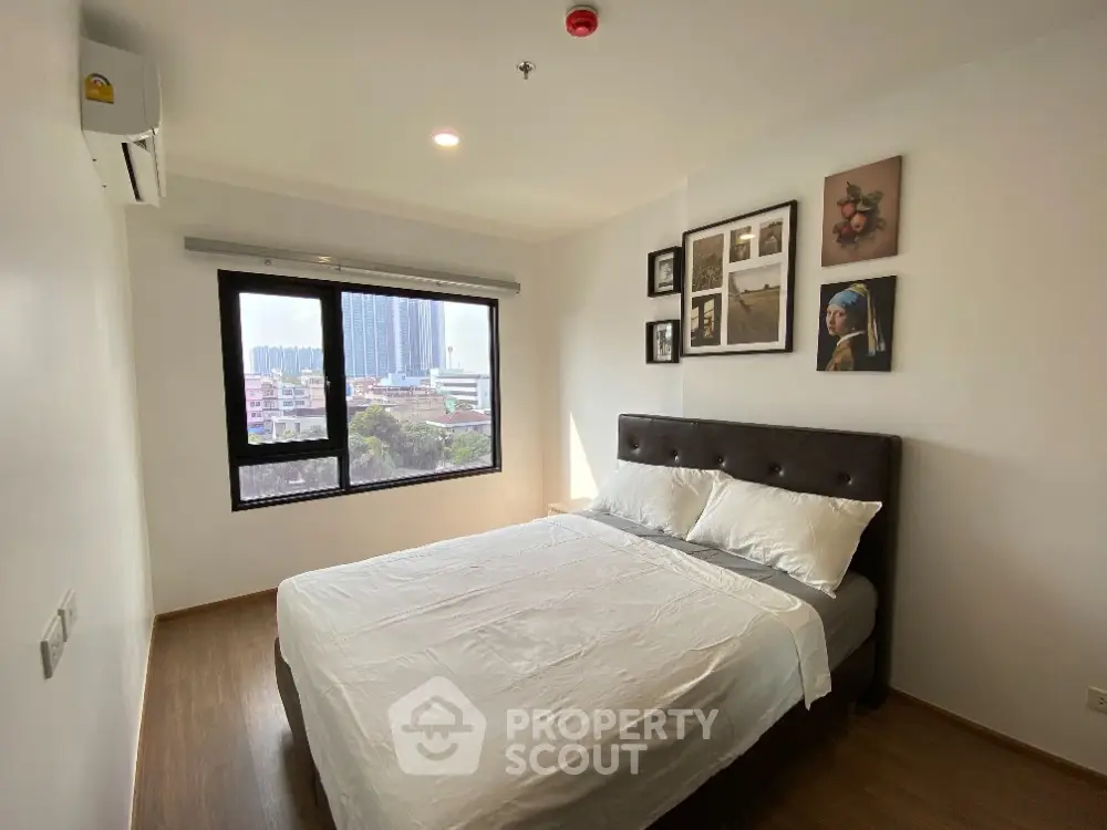 Modern bedroom with city view and stylish decor in high-rise apartment