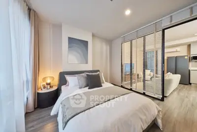 Modern bedroom with stylish decor and open layout to living area