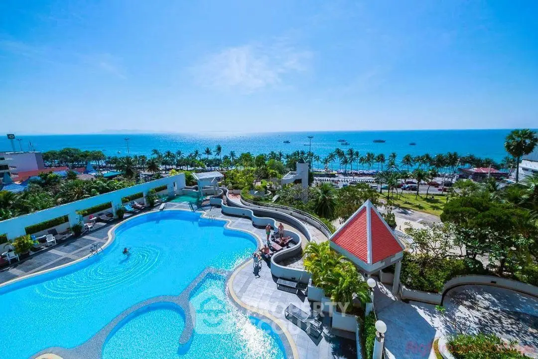 Stunning ocean view from luxury poolside with lush greenery and clear blue skies.
