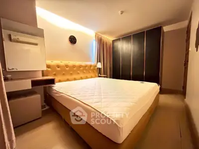 Spacious bedroom with modern design and ample storage in a stylish apartment.