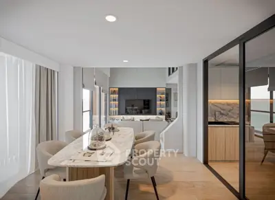 Luxurious open-plan dining and living area with modern decor and ocean view.