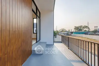 Spacious balcony with modern railing and scenic view, perfect for relaxation and outdoor enjoyment.