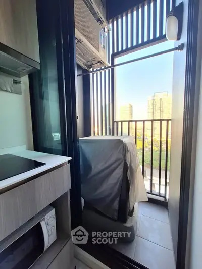 Compact balcony with city view, featuring modern appliances and sleek design, perfect for urban living.