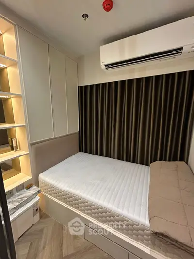 Cozy bedroom with built-in storage and modern air conditioning unit.