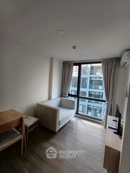 Modern living room with large window and minimalist furniture in urban apartment