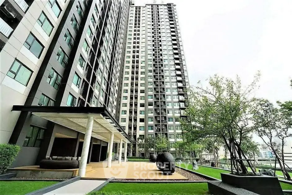 Modern high-rise building with lush garden and outdoor seating area, perfect for urban living.