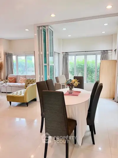 Spacious living and dining area with elegant decor and natural light