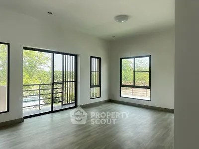 Spacious empty room with large windows and natural light