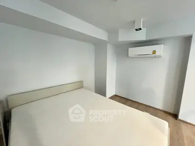 Spacious bedroom with modern air conditioning and minimalist design