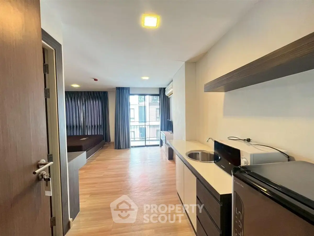 Modern studio apartment with open layout and balcony view