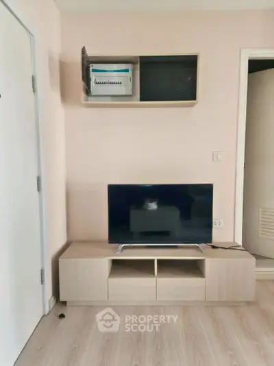 Modern living room with sleek TV stand and wall-mounted cabinet