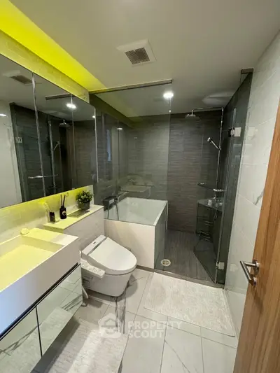 Luxurious modern bathroom with glass shower and sleek fixtures