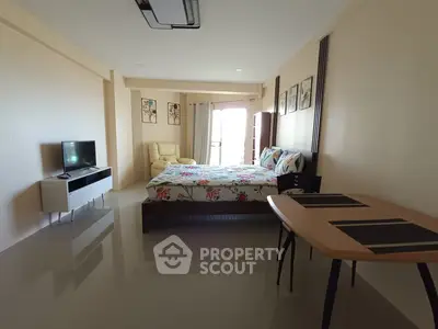 Spacious bedroom with modern decor and natural light in a stylish apartment.